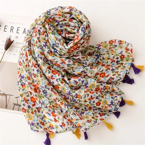 Lightweight floral print scarf with multi-colored tassels on a white background