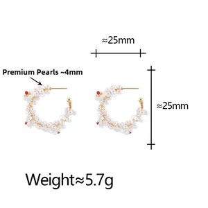 Detail of C-shaped pearl earrings with red beads, 25mm diameter and 5.7g weight
