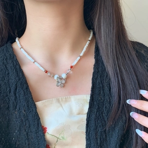 Elegant beaded butterfly necklace for women with white pearls and sparkling crystal charms