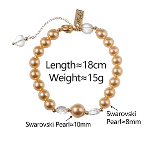 Champagne gold pearl bracelet with faceted crystal beads and heart pendant on white background