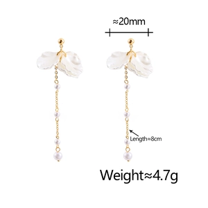 Detailed view of long tassel flower earrings with pearls measuring 8cm in length