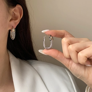 Elegant silver U-shaped earrings featuring a textured woven pattern for women