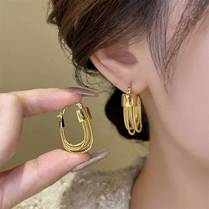 Elegant gold fringe earrings featuring snake chain tassels and a polished U-shaped buckle