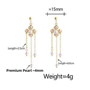 Detail view of pearl flower earrings with dimensions showing long golden tassels