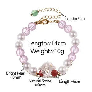Handmade beaded bracelet with white pearls, purple crystals and a white flower charm