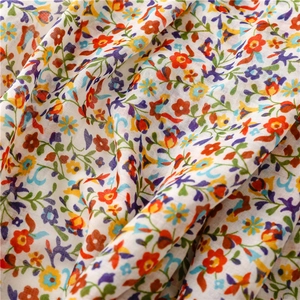 Close-up of floral print fabric with soft texture and vibrant small flower patterns