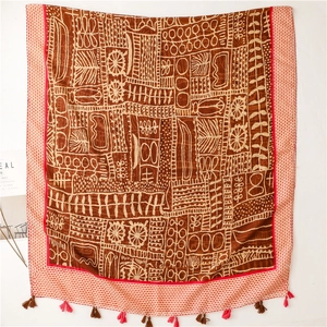 Ethnic bohemian brown scarf with tribal prints, red border and colorful tassels