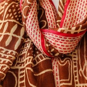 Close-up of Bohemian tribal print scarf featuring earth-toned geometric patterns and fine texture