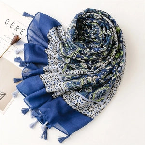 Blue and white floral cotton-linen scarf with tassels and ethnic patterns on white background