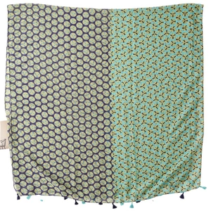 Linen feel scarf with green polka dots and fringe details on purple teal fabric