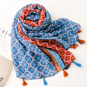 Bohemian ethnic print scarf in blue and orange with fringe details for travel
