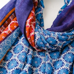 Close-up of bohemian blue and orange scarf showing fine fabric texture and pattern