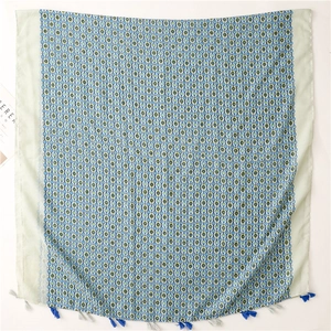 Blue floral bohemian scarf with fringe tassels for sun protection and travel styling