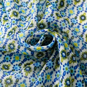 Detailed macro view of retro blue and yellow floral pattern on breathable linen scarf fabric
