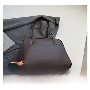 Macro shot of dark brown leather tote bag with front pocket and double handles