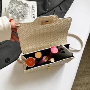 Detail view of the woven shoulder bag interior showing capacity for phone and cosmetics