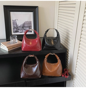 Close-up of retro pillow bags in multiple colors with embossed logo and metal buckles
