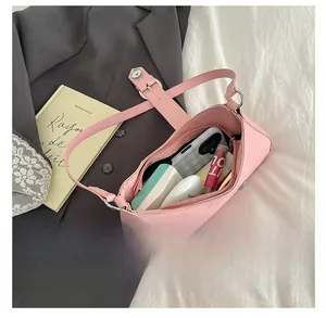 Interior view of pink baguette bag showing storage space for phone and cosmetics