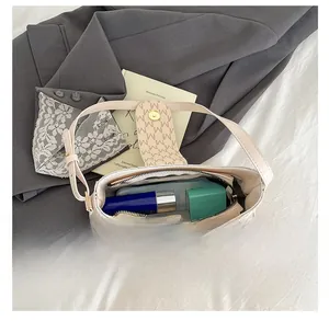 Internal view of beige PU shoulder bag showing storage capacity for phone and cosmetics