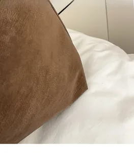 Detailed close-up of premium brown faux suede material showing soft matte texture