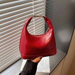 Vintage red glossy leather crescent handbag with embossed logo and gold metal clasp