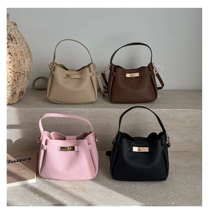 Detail view of colorful bucket bags with lychee pattern and gold metal twist locks