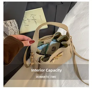 Detailed interior view of beige lychee leather bucket bag with golden turn-lock and straps