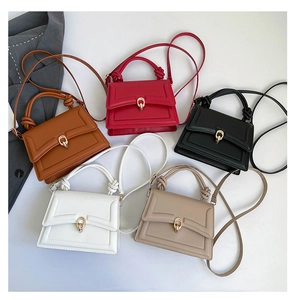 Detail of five stylish trapezoid handbags featuring knotted handles and gold metal locks