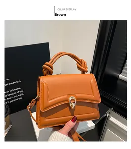 Brown faux leather crossbody bag with distinctive knot handle and golden twist lock detail