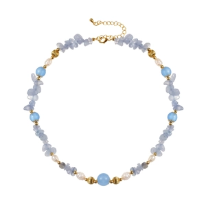 Close-up of pearl and light blue irregular stone necklace with gold lobster clasp