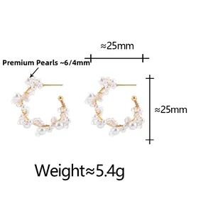 Detailed view of gold hoop earrings with white faux pearls and clear crystals, 25mm size