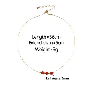 Detail of red agate and crystal pendant necklace with adjustable gold chain clasp