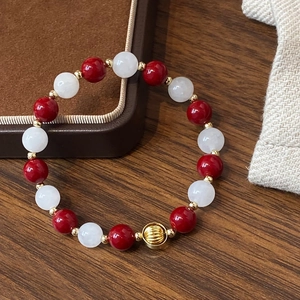 Handcrafted red pearl and white natural stone beaded bracelet with gold plated accents