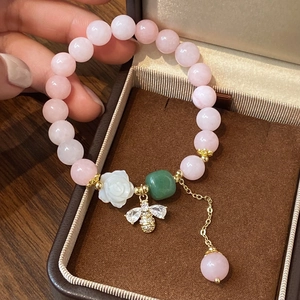 Pink strawberry crystal beaded bracelet with white camellia and bee charm detail