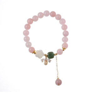 Pink strawberry crystal beaded bracelet with rose flower and honey bee charms in white background