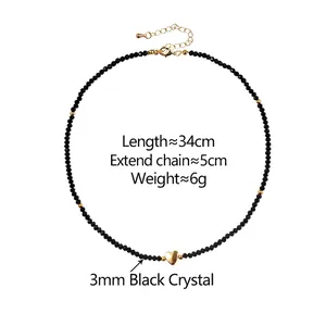 Minimalist handmade beaded necklace featuring black crystals and a gold heart pendant