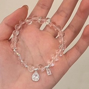 Pink crystal beaded bracelet with zircon teardrop pendant worn on a wrist for daily style