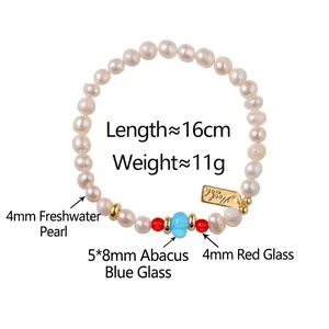 Handmade freshwater pearl bracelet with red carnelian and blue beads on white background