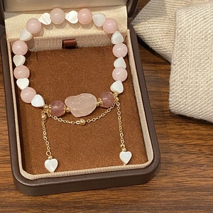 Pink strawberry crystal beaded bracelet with gold chain heart pendant on velvet box