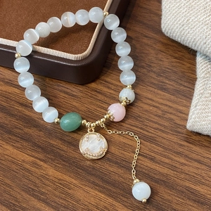 Natural cat eye stone beaded bracelet with white shell smiley face pendant and gold accents