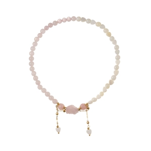 Pink strawberry quartz beaded bracelet with gold heart charms and raw crystal centerpiece