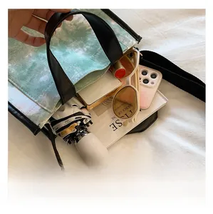 Interior capacity of green tie-dye canvas tote bag showing umbrella, phone, and sunglasses