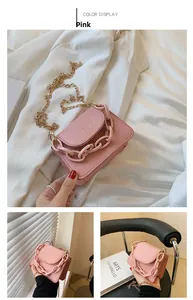 Pink lychee grain crossbody bag featuring a thick decorative chain and gold metal strap