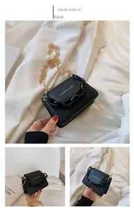 Close-up of black PU leather mini crossbody bag featuring chunky resin chain and gold hardware