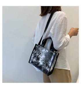 Close-up of the black and white forest art print and leather handles on the tote bag