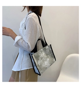 Detail of canvas tote bag with tie-dye pattern and adjustable black shoulder strap