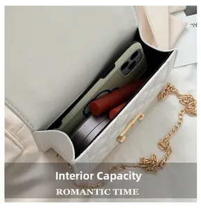 Interior view of white quilted chain bag showing capacity for phone and cosmetics