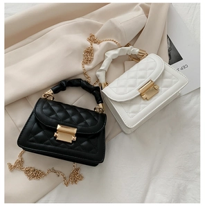 Detail of mini quilted leather flap bags in black and beige with gold chain strap