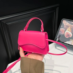 Mini hot pink shoulder bag with wavy flap design and adjustable strap for women