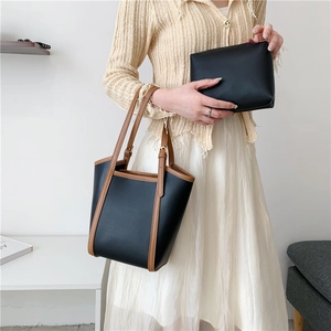 Black leather tote bag with brown straps and matching pouch for women's casual fashion